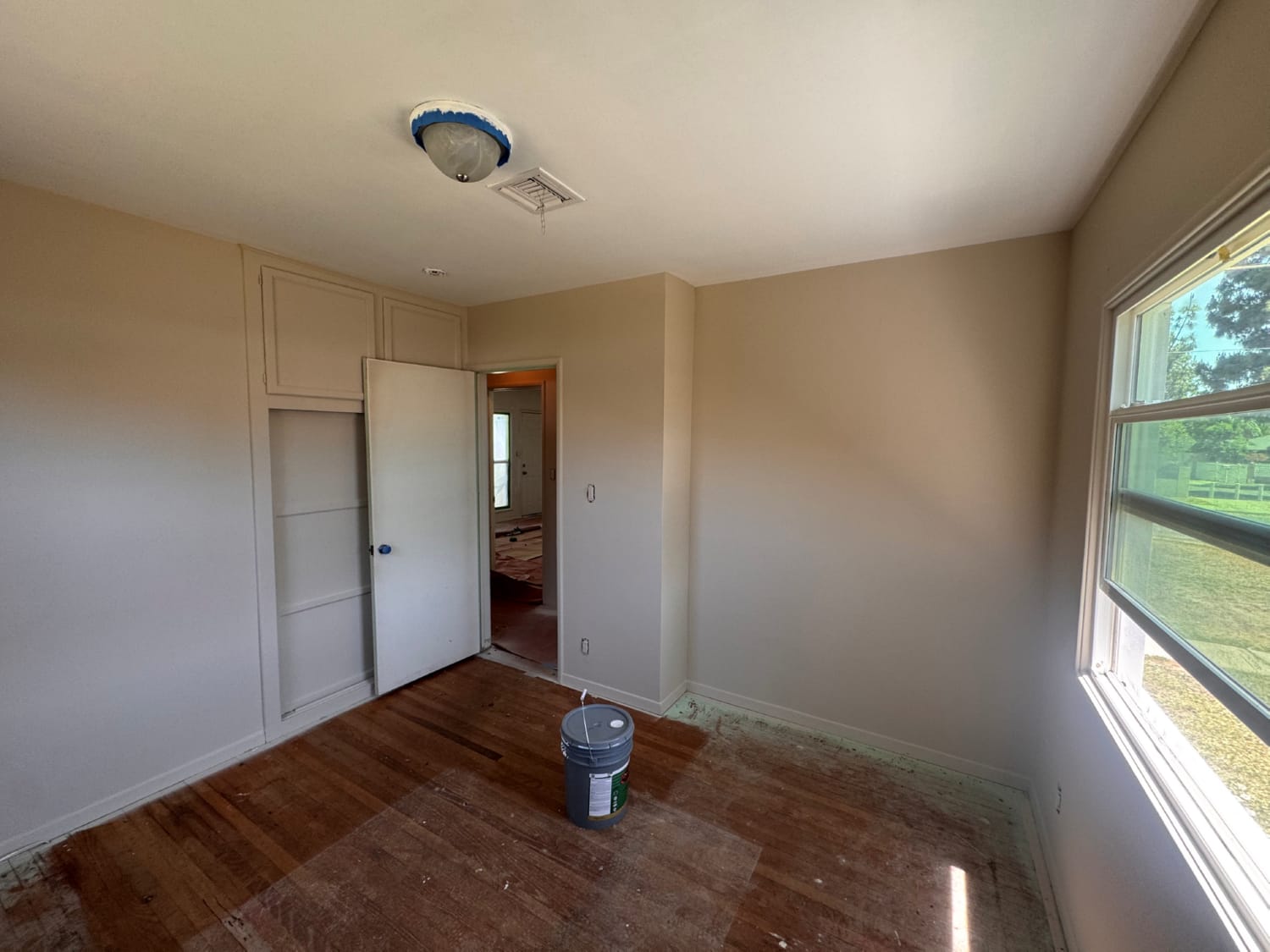 Professional painter using roller on interior walls