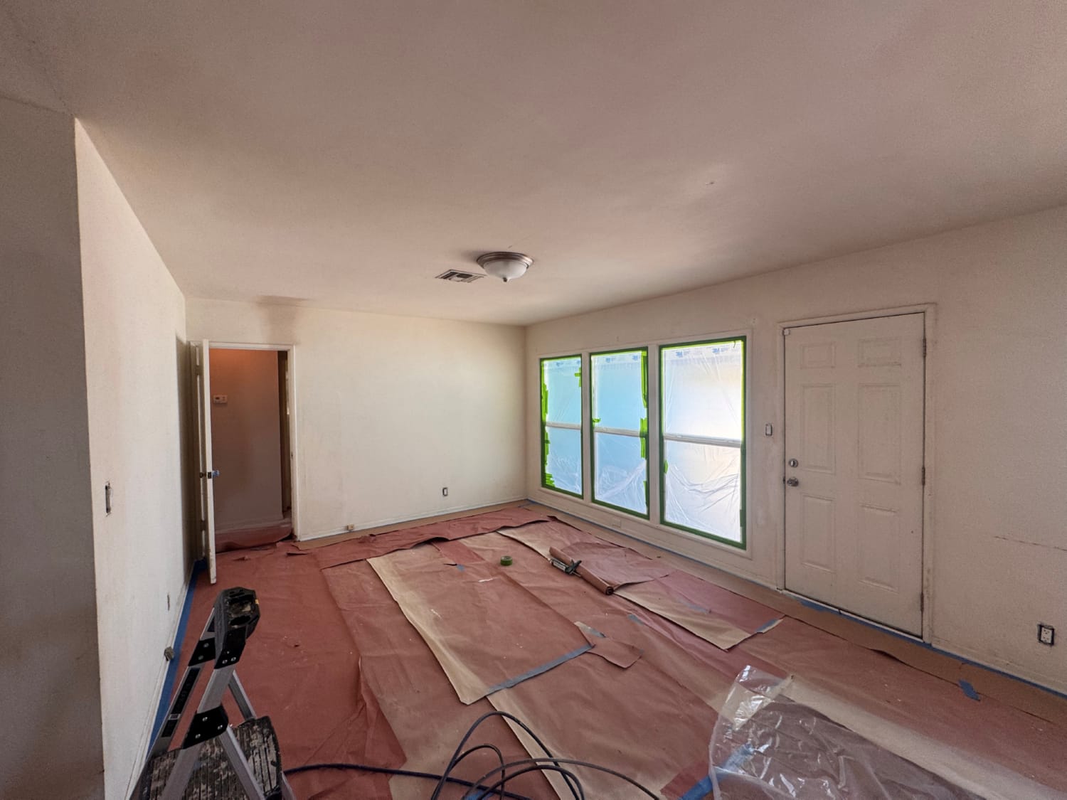 Exterior painting two-story house with scaffolding