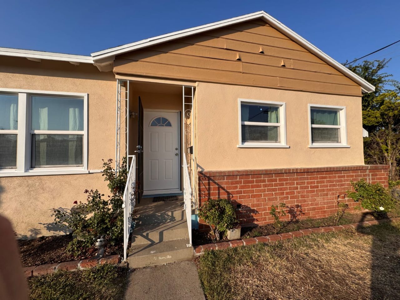 Professional exterior house painting two-story stucco home with fresh coat